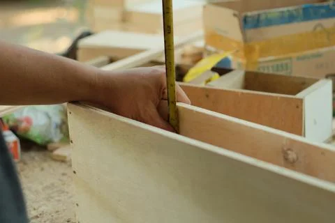 Carpenter working in workshop. carpenter measuring using pencil and ruler. Stock Photos