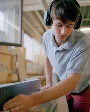 Carpenter working in a workshop Stock Photos