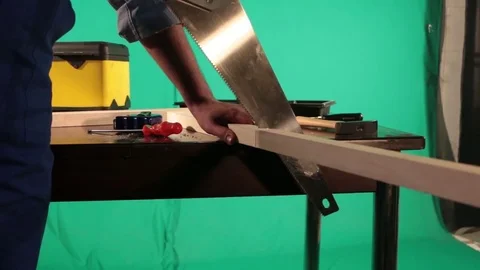 Carpenter works on the background of green screen Stock Footage 77840448