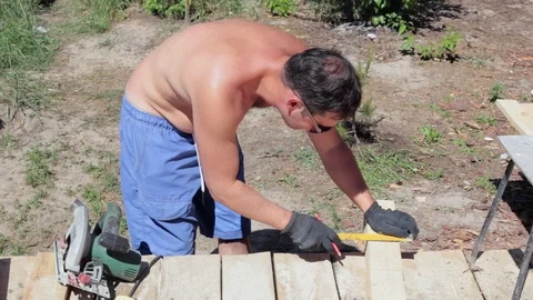 The carpenter works with the circular saw. Stock Footage 90290548