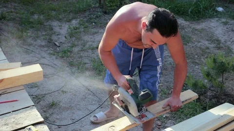 The carpenter works with the circular saw. Stock Footage 90290833