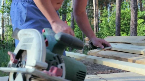 The carpenter works with the circular saw. Stock Footage 90291196