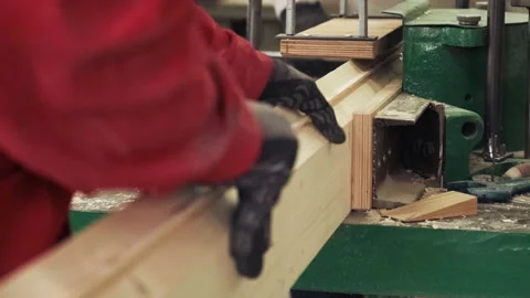 Carpenter works on the jointer-planer or surface planer with wooden plank.  Wood 動画素材 235838269
