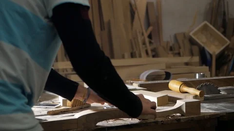 The carpenter works with the plane. Handles table leg Stock Footage 99583208