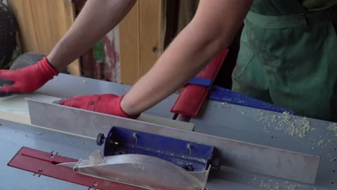Carpenter works on planing machine in workshop. Wood processing Stock Footage 167613337