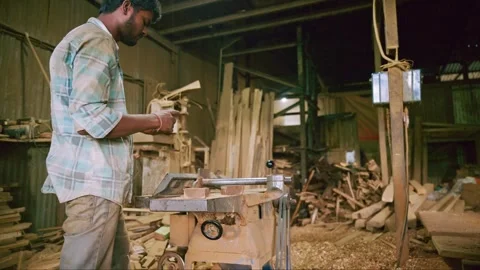 Carpenter works in shop using machine to cut timber Stock Footage 301437898