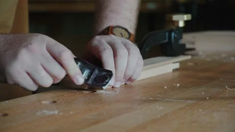 A carpenter works with a small jack-plane Stock Footage 156515345