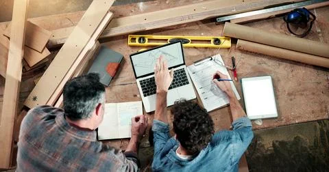 Carpenter, workshop and above of men on laptop for planning, production schedule Stock Photos