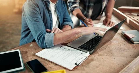 Carpenter, workshop and hands of men on laptop for planning, production schedule Stock Photos