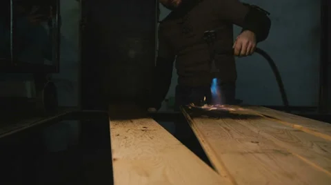A carpenter in a workshop burns wood Video stock 58964207