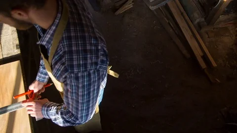 The carpenter in the workshop measures the workpiece, a shot from above Stock Footage 84547828