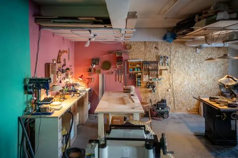 Carpenter workshop with power tools and workbench, morning work setup with Stock Photos