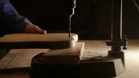 Carpenter in the workshop working on the drilling machine Stock Footage 100878788
