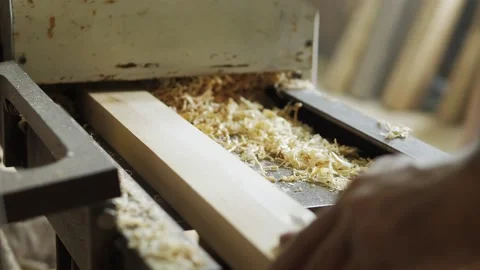 A carpenter in the workshop works on a woodworking machine, processes wood for Stock Footage 196938573