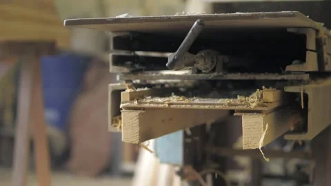 A carpenter in the workshop works on a woodworking machine, processes wood for Stock Footage 201300644