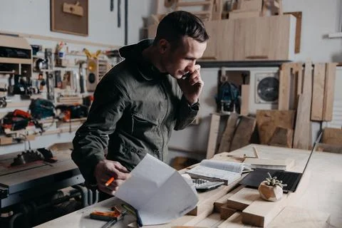 Carpenter writes on a notebook Stock Photos