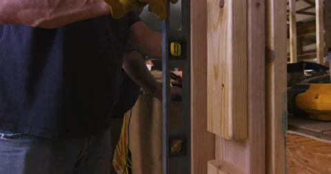 Carpenters Checking Wall Framing with Spirit Level Stock Footage 342839886