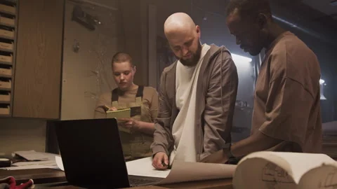 Carpenters Discussing Plan as Apprentice Taking Notes in Woodworking Workshop Video stock 292780662