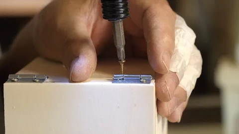 Carpenter's hands use a drill, close up Stock Footage 89648709