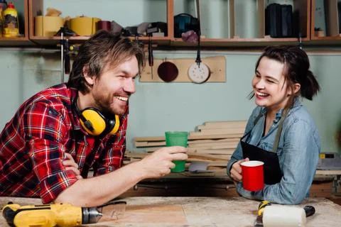 Carpenters having break from their work in wood workshop Stock Photos