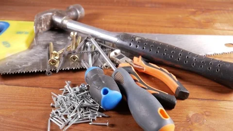 The carpenter's tools lie on a wooden table. Hammer, screwdrivers, nails. The Stock Footage 73830210