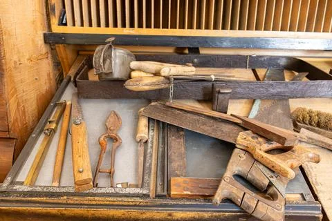 Carpenter's work workshop table with tools from the last century Stock Photos