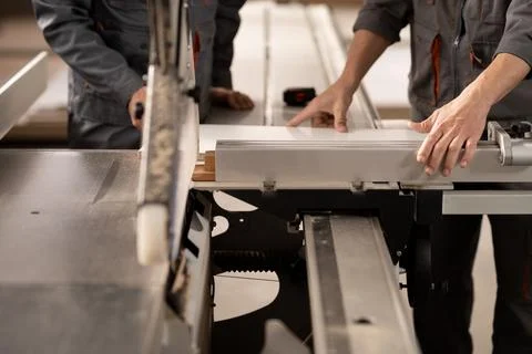 Carpenters working in workshop with tools and electric saws in the process of Stock Photos