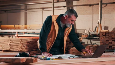 Carpentry, checklist or man in workshop with laptop, stock check or process Stock Footage 337994889
