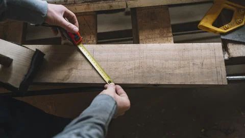 Carpentry concept with man measuring Stock Photos
