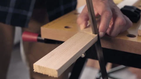 Carpentry, cutting wood slat using hand saw Stock Footage 179576424