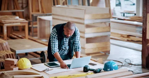 Carpentry, documents and laptop with black man in factory for manufacturing Stock Footage 331571334