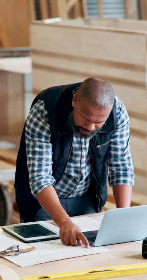 Carpentry, documents and laptop with black man in workshop for checklist, online Stock Footage 331624284