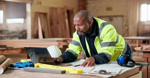 Carpentry, documents and laptop with black man in workshop for checklist or Stock Photos