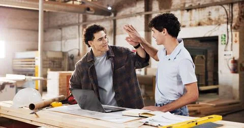 Carpentry, high five and men with laptop for warehouse, planning and startu.. Stock Photos