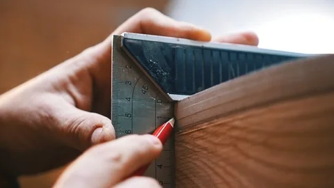 Carpentry industry - a woodworker making marks for cutting on the wooden detail Stock Footage 120541343