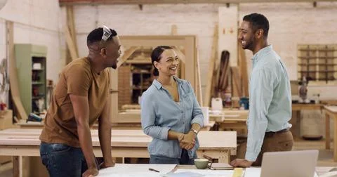 Carpentry, laughing and talking with team in factory for manufacturing or p.. Stock Photos