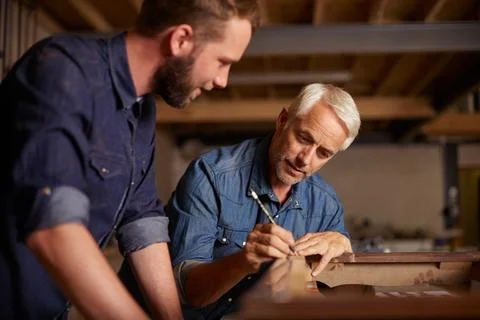 Carpentry, learning and man with apprentice in training, teaching and tips for Stock Photos