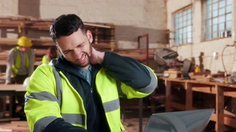 Carpentry, neck pain or man in factory with laptop, burnout or joint strain with Stock Footage 338049915
