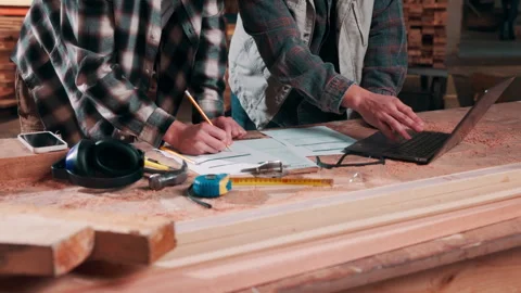 Carpentry, team or hands in workshop with laptop, stock check or discussion in Stock Footage 337995291