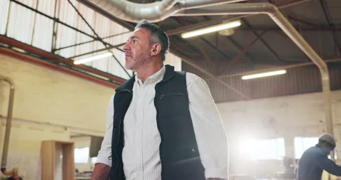 Carpentry, thinking and walking with man in warehouse for management of Stock Footage 340003692