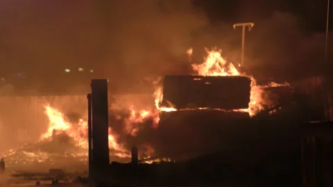 Carpentry timber wood warehouse on fire, huge red flames, pollution Video stock 184112013