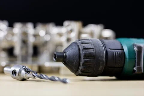 Carpentry tools and accessories on a workshop table. Hinges and screws togeth Stock Photos