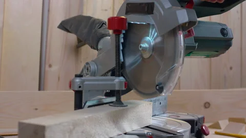 Carpentry work. Cuts board with a miter saw. Stock Footage 169359025