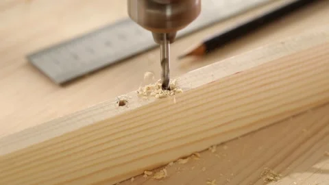 Carpentry work. drilling a hole in a piece of wood. Stock Footage 245412434