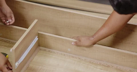 Carpentry workers are assembling desk furniture with professional aptitude. Stock Footage 166405410