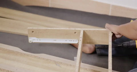 Carpentry workers are assembling desk furniture with professional aptitude. Stock Footage 166405541