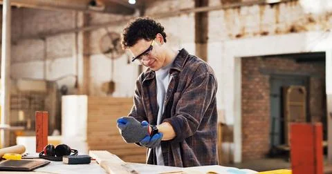 Carpentry, workshop and man with wrist pain for accident, woodworking injur.. Stock Photos