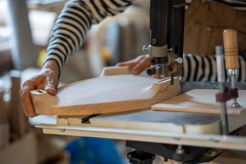 Carpentry workshop, craftsman master working. Joiner hands carved on wood with Stock Photos