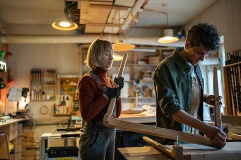 Carpentry workshop, craftsmen working together. Manufacture of furniture, wooden Stock Photos