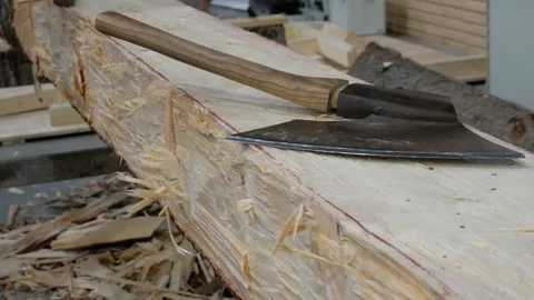Carpentry workshop. Handmade wooden beam. Work with a carpenter's ax. Stock Footage 167659225